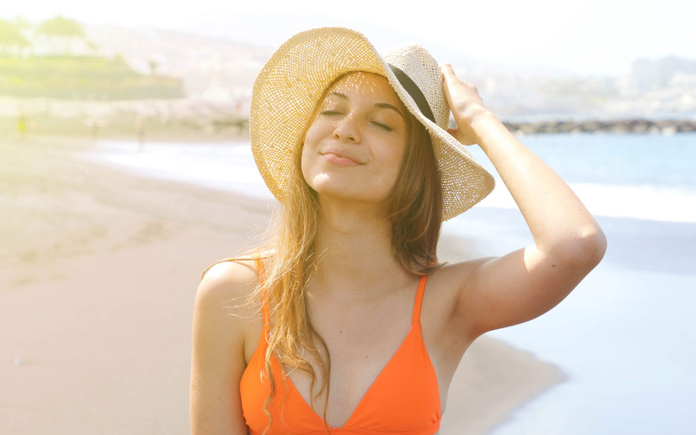 woman on the beach soaking up the sun