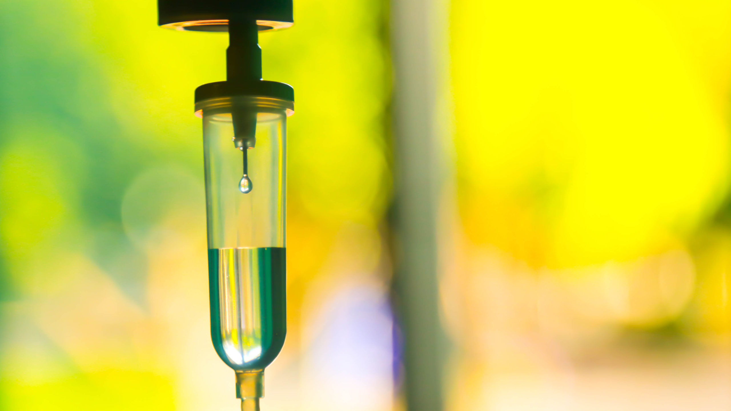 iv vitamin drip with a yellow and green background