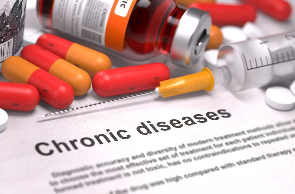 needle with pills and a chronic diseases sign