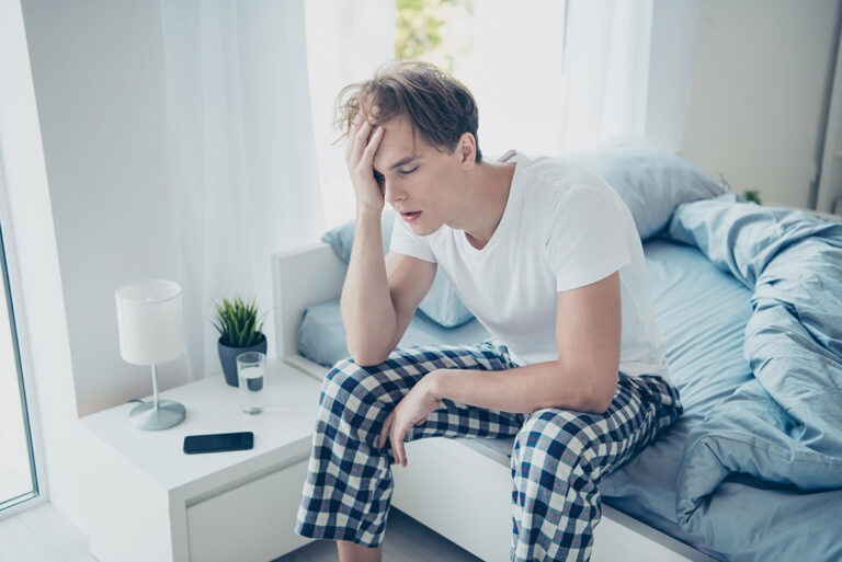 man in pajamas hungover needs iv hydration therapy