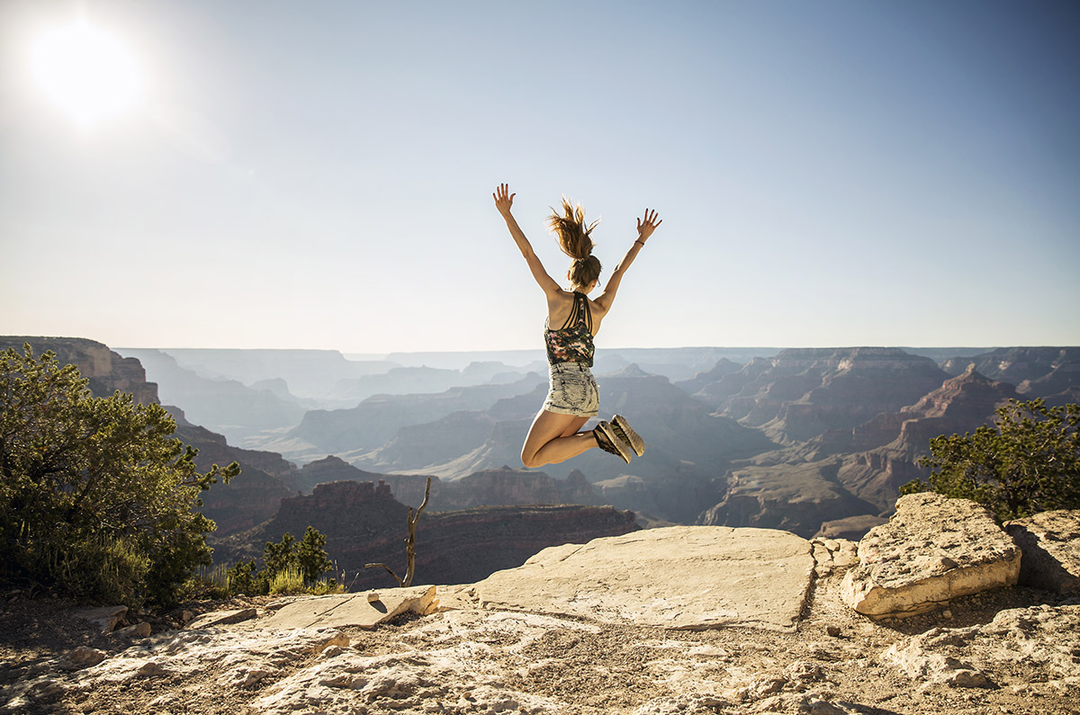girl jumping outdoors on mountain feeling energetic from myers cocktail