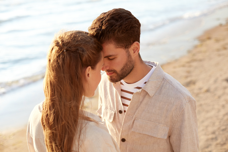 Couple standing on the shore of the beach